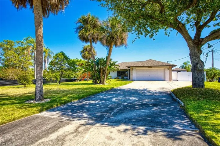 Single story home with an attached garage and concrete driveway