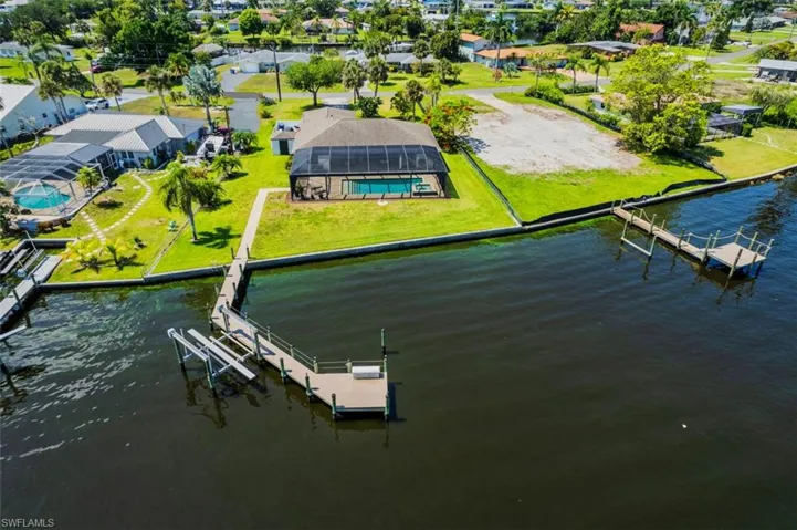 Aerial view of residential area featuring a nearby body of water