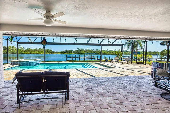 Slider's open to the outdoor pool area with a river view.