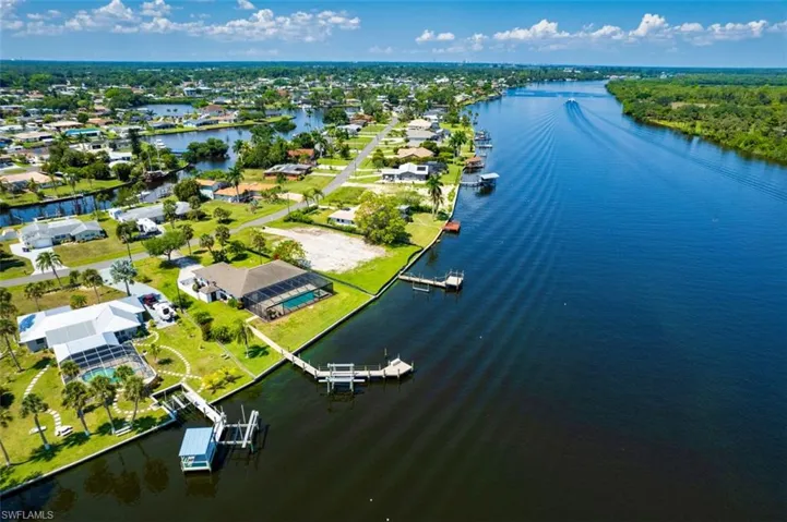 Aerial view of residential area featuring a large body of water