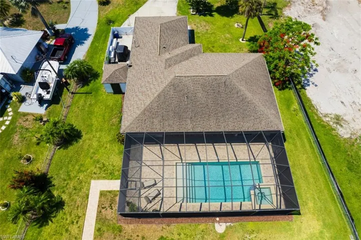 Aerial view of property and surrounding area featuring a pool