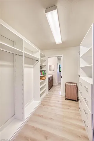 One of two primary bedroom closets with built ins.