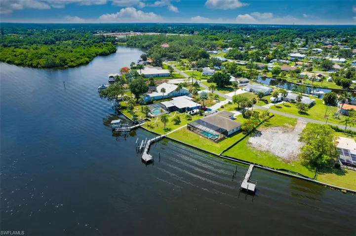 Aerial view of residential area featuring a nearby body of water