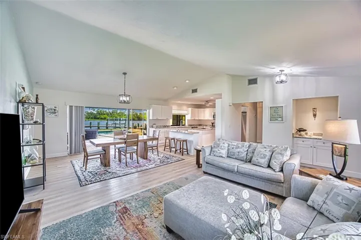 Living room featuring raised ceiling, lvt flooring.