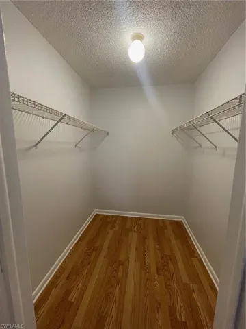 Walk in closet featuring wood finished floors