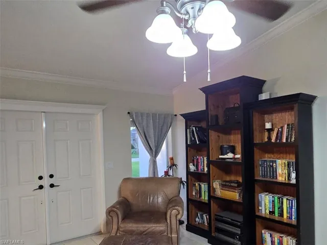 Sitting room featuring ornamental molding and light tile patterned floors