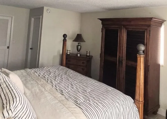 Bedroom with a textured ceiling