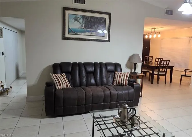 Living room featuring light tile patterned flooring and baseboards