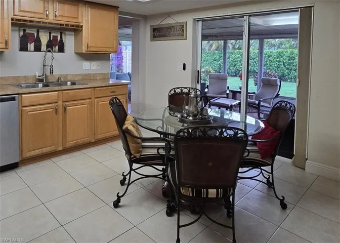 Dining space with light tile patterned flooring