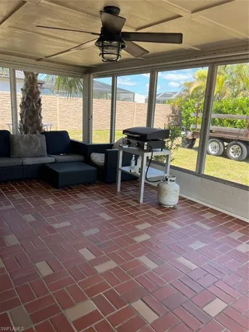 Sunroom with a ceiling fan and outdoor lounge area