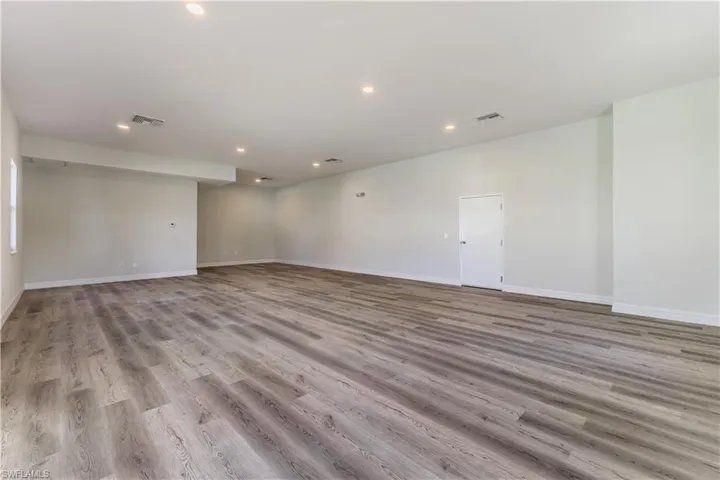 Empty room featuring light wood finished floors and recessed lighting
