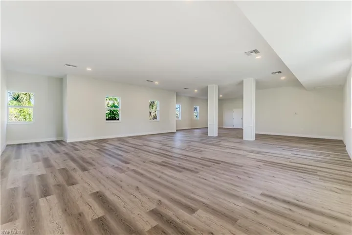 Unfurnished living room with light wood-type flooring and recessed lighting