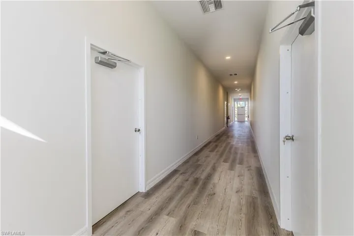 Corridor featuring recessed lighting and light wood-style floors