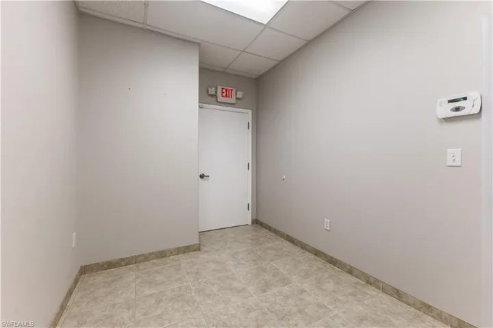 Spare room featuring baseboards and a drop ceiling