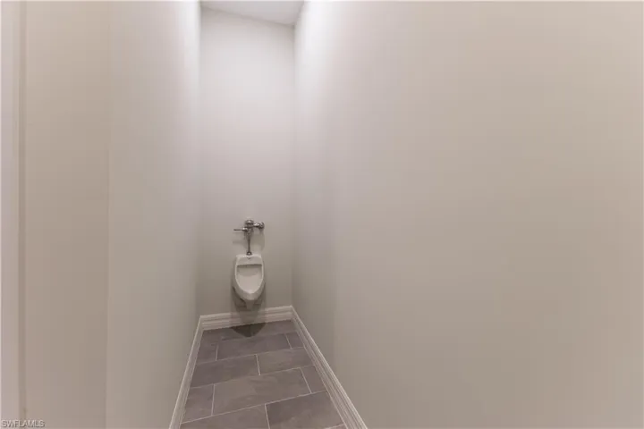 Bathroom with baseboards and light tile patterned flooring