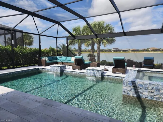 Outdoor pool with an outdoor living space, a water view, and a patio