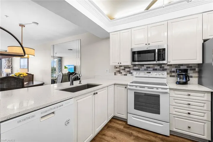 Remodeled and updated kitchen allows for an unobstructed view all the way out to the golf course!