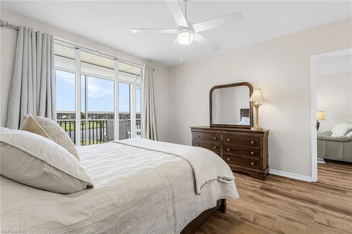 Master bedroom has a line of sight through the expansive lanai out to the course.