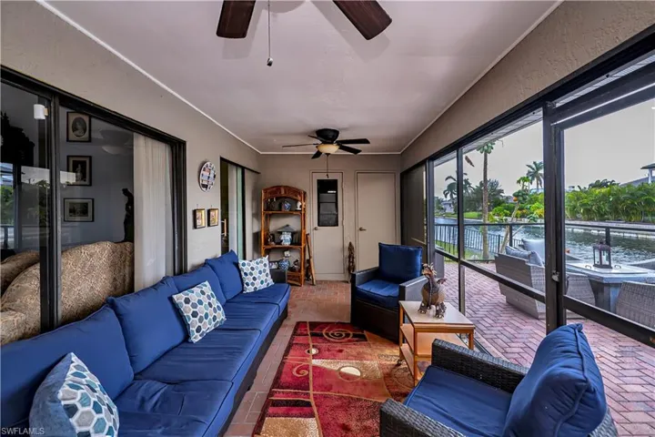 Sunroom featuring ceiling fan
