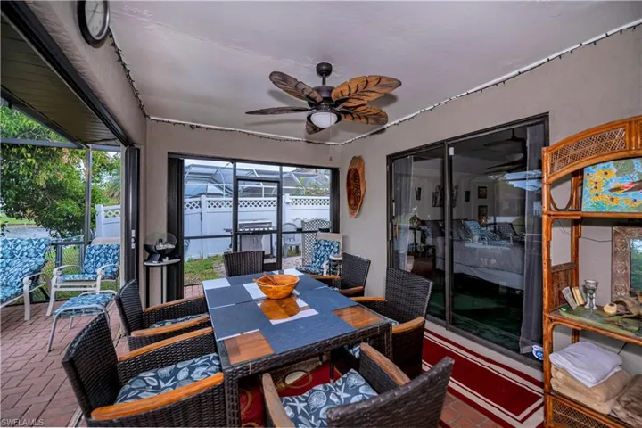 Sunroom featuring ceiling fan and a wealth of natural light