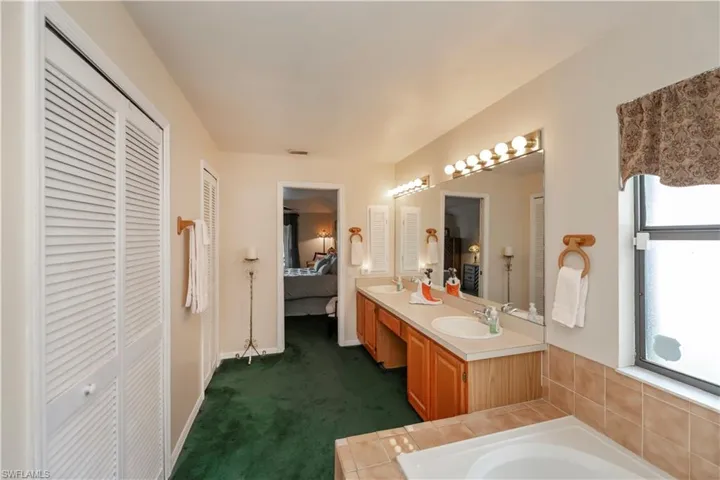Bathroom featuring vanity and a tub