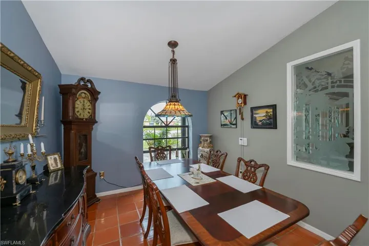 Dining room featuring tile patterned flooring and vaulted ceiling