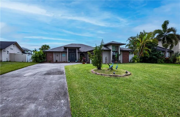 Single story home featuring a front lawn