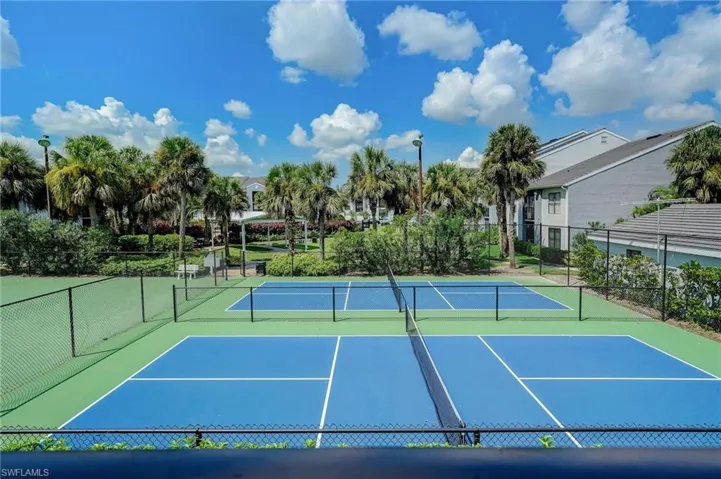 Pickleball courts featuring blue playing areas and green surrounds