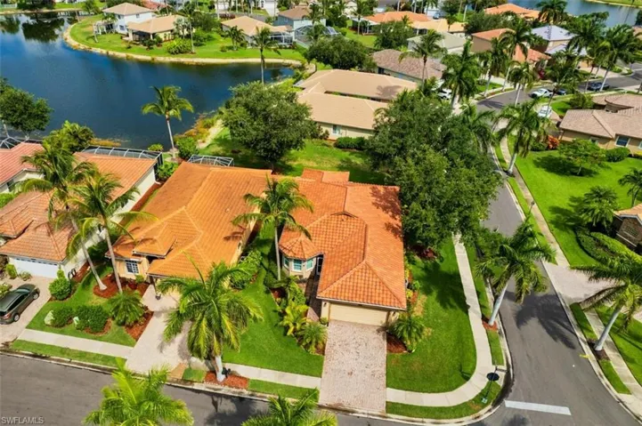 Birds eye view of property with a water view