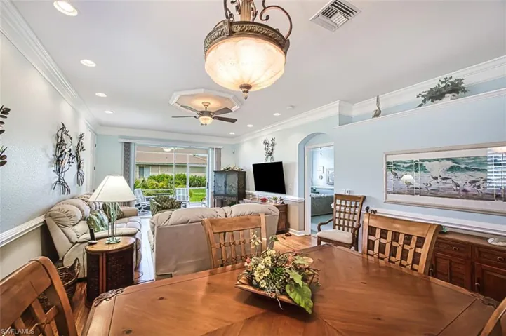 Dining room featuring ceiling fan, hardwood / wood-style floors, and ornamental molding