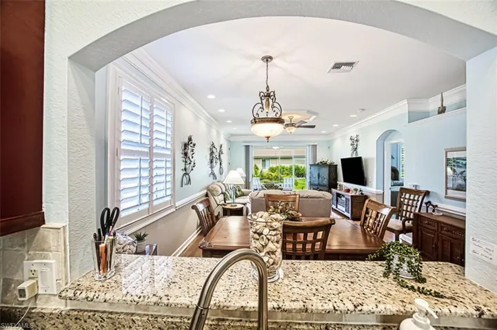 Dining area featuring ornamental molding and ceiling fan
