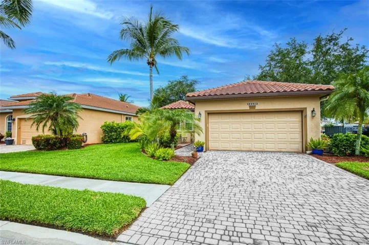 Mediterranean / spanish home with a front lawn and a garage