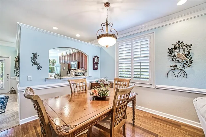 Dining space featuring tile flooring, ornamental molding, and plenty of natural light