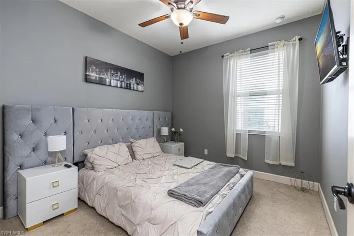 Bedroom featuring light colored carpet and ceiling fan