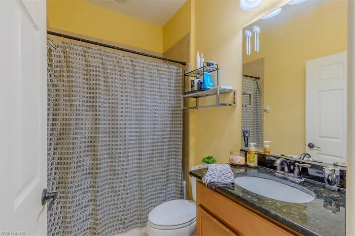 Full bathroom featuring vanity and a shower with shower curtain