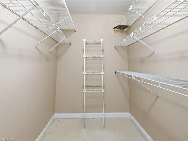 Spacious walk-in closet featuring multiple wire shelving units with adjustable levels, providing abundant storage capacity