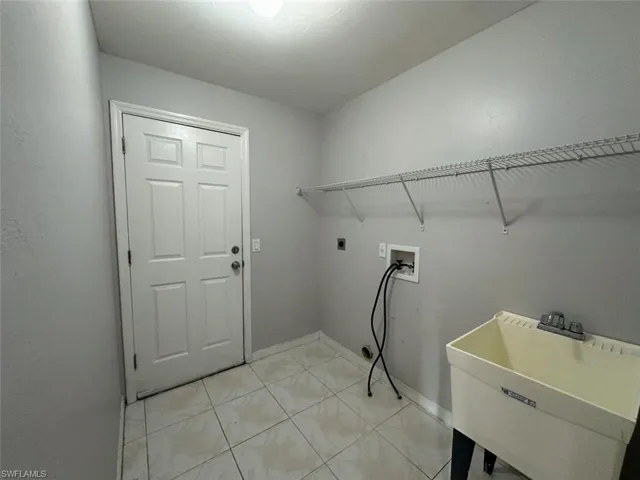 Laundry area with hookup for a washing machine and hookup for an electric dryer