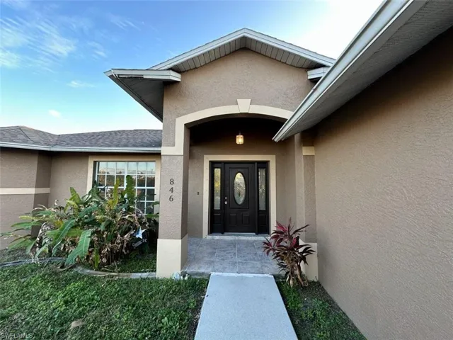 Doorway to property with stucco siding