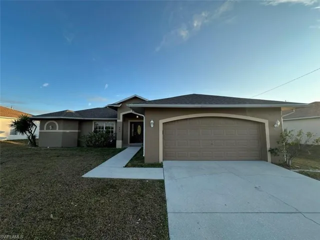Ranch-style home featuring stucco siding, concrete driveway, and a garage