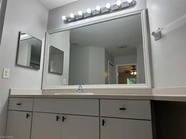 Bathroom featuring vanity and a ceiling fan