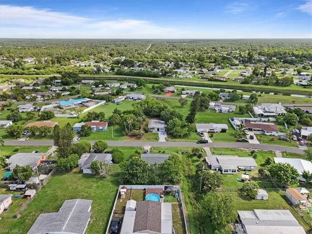 Aerial view of property's location featuring nearby suburban area