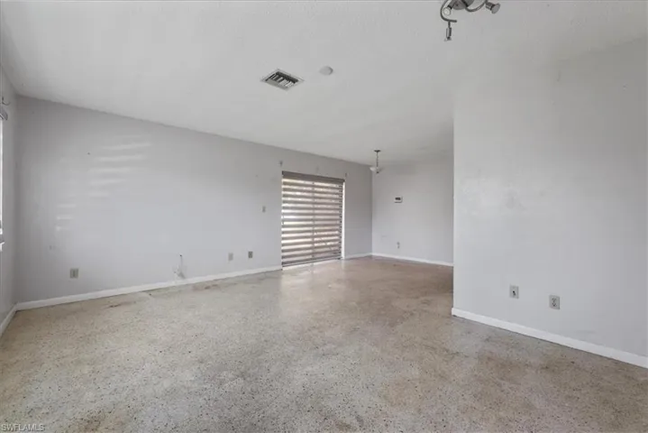 Spare room with speckled floor and a textured ceiling