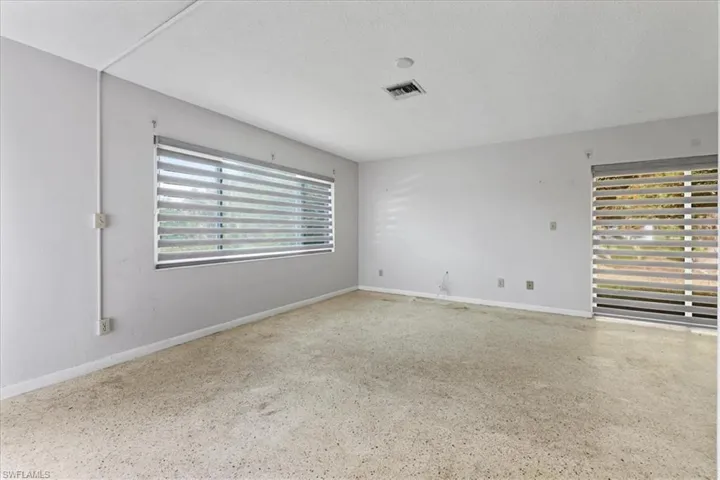 Spare room featuring a textured ceiling and speckled floor
