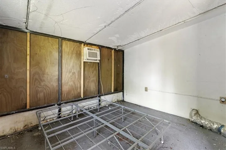 Below grade area with an AC wall unit