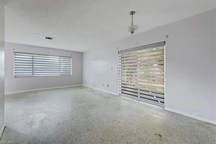 Spare room featuring speckled floor and a textured ceiling