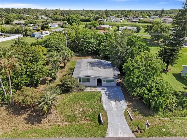 View from above of property featuring a tree filled landscape