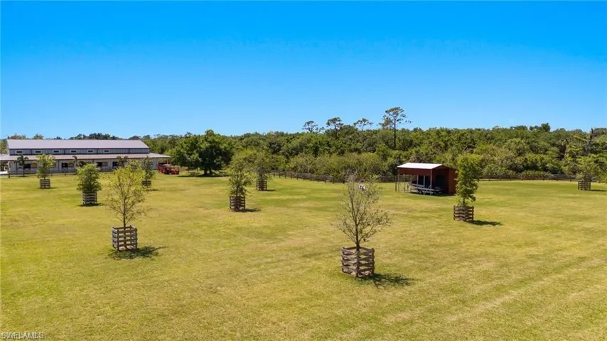View of yard with a rural view and an outbuilding