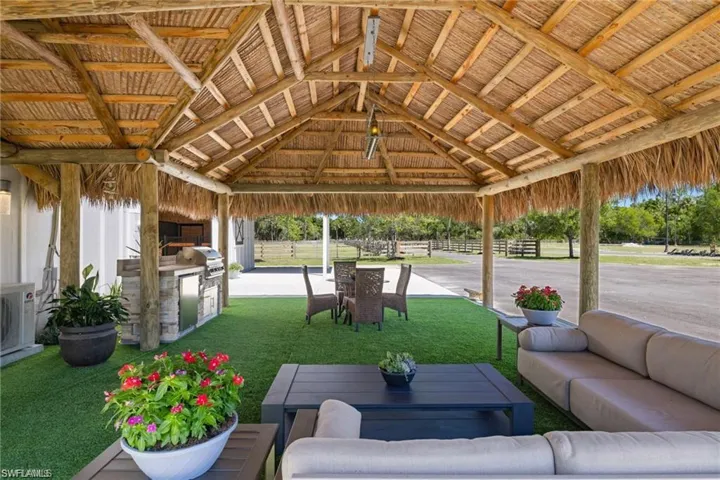 View of patio with a gazebo, an outdoor kitchen, and a grill