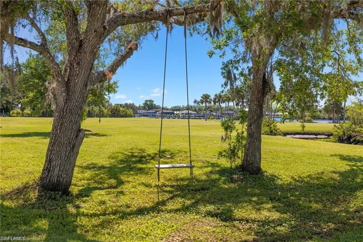 View of home's community with a lawn