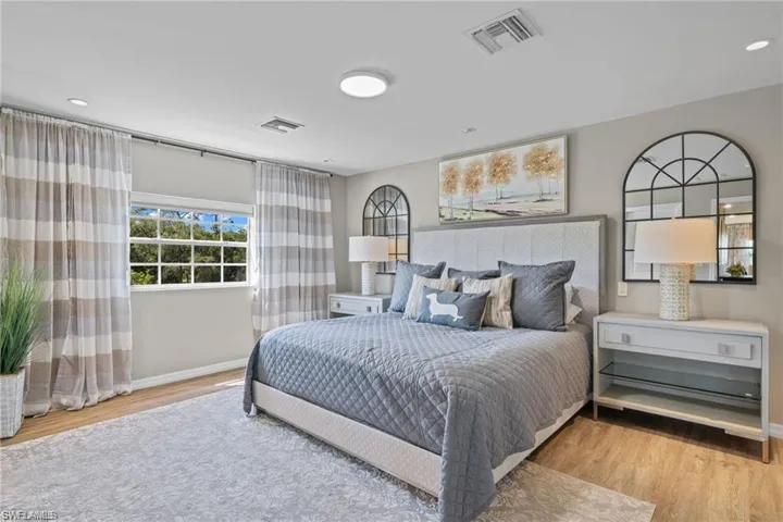 Bedroom with light hardwood / wood-style flooring